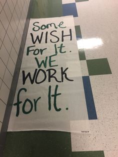 a sign that says some wish for it we work for it on the floor in a bathroom