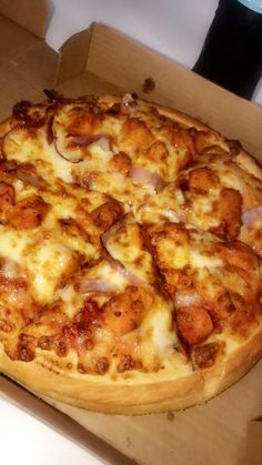 a pizza sitting in a box on top of a counter