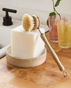 a wooden brush on top of a block of soap