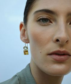 Meet our Duo Earrings! Gorgeous, graphic semiprecious stones framed in 14k gold. We love these pairs for everyday & event wear alike – choose your favorite stone combination and let the compliments flow in! In 14k gold with a green amethyst oval top and citrine square bottom. Faceted green amethyst oval and citrine square stone earrings with 14k gold bezels Drop: 1.0" Total gemstone carat weight: 13.35 Handmade by goldsmiths in Thailand; treat with care Ships in 1-3 days For information on how t Fusion Yellow Gold Earrings With Gemstone Accents, Fusion Style Yellow Gold Earrings With Gemstone Accents, Yellow Gold Fusion Earrings With Gemstone Accents, Modern Multi-stone Yellow Gold Earrings, Modern Yellow Gold Multi-stone Earrings, Modern Gold Earrings With Gemstone Accents, Square Stone Earrings, Amethyst And Citrine, Hoop Charms