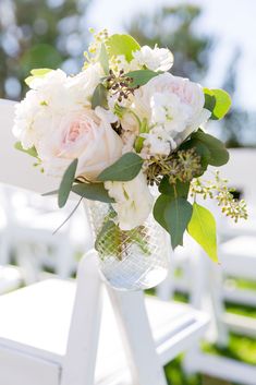 a bouquet of flowers sitting on top of a white chair