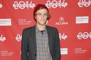 a man standing in front of a red wall