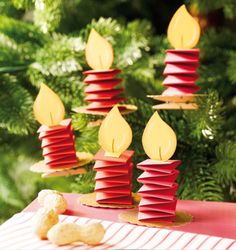 some red and yellow candles sitting on top of a table