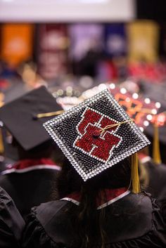 a group of people in graduation gowns and caps with beaded decorations on them