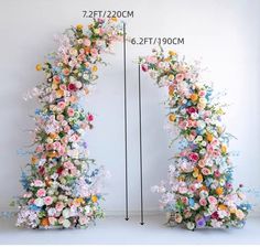 an arch made out of flowers is shown with measurements