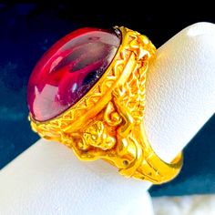 Elizabeth Taylor’s Collection Signature “Gilded Age” Cherubs 22 Karat Gold Plated Ruby Red Ring Size: 9 Ecu Collectible Gold Ruby Rings, Gold Ruby Rings For Collectors, Gold Cabochon Ruby Ring For Weddings, Gold Ruby Cabochon Ring For Wedding, Gold Ruby Ring With Intaglio For Gift, Elizabeth Taylor Jewelry, Red Ring, Red Rings, Taylor S