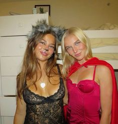 two women dressed up in costumes posing for the camera