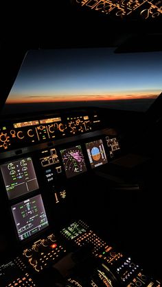 an airplane cockpit at night with the lights on