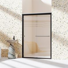 a bathroom with a glass shower door next to a white sink and marble counter top