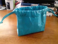 a blue bag sitting on top of a wooden table