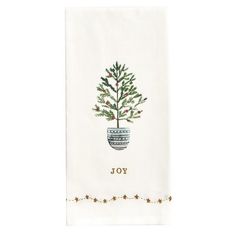 a white towel with a christmas tree on it and the word joy written in gold