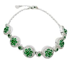 This bracelet features a combination of emerald green nanocrystal and created white sapphires, set in a halo design. The nano emeralds, ranging from 2.0mm to 1.9mm, add a green hue, while the created white sapphires, varying from 0.8mm to 1.1mm, provide contrast. This bracelet is crafted in rhodium over sterling silver, ensuring durability and brilliance. White Gold Emerald Bracelets, White Gold Emerald Bracelet, Round White Gold Bracelets With Emeralds, Green Cubic Zirconia Gemstone Bracelets, Green Gemstone Bracelets In Cubic Zirconia, Green Cubic Zirconia Round Tennis Bracelet, Round Green Diamond Emerald Bracelet, Green Round Cubic Zirconia Tennis Bracelet, Green Cubic Zirconia Tennis Bracelet