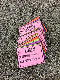 four pink luggage tags with the word login on them sitting on top of carpet