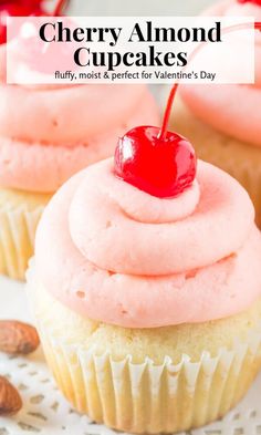 cupcakes with pink frosting and cherries are on a white platter