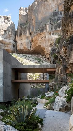 a house built into the side of a mountain with a walkway going up to it