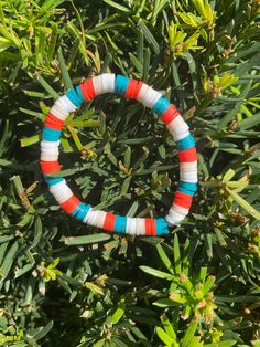 a beaded bracelet sitting on top of a bush