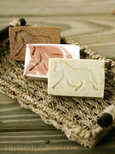 three soap bars sitting on top of a wicker basket