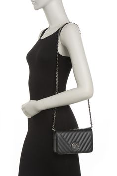 This slim crossbody bag features classic details for a stylish look. . Nonadjustable chain shoulder strap. Foldover flap with magnetic closure . Exterior features logo metal hardware, quilted construction . Approx. 6" H x 8' W x 2" D. Approx. 23.5" adjustable shoulder strap. Imported PU exterior, fabric lining Formal Quilted Crossbody Flap Bag, Quilted Crossbody Flap Bag For Evening, Evening Quilted Crossbody Flap Bag, Badgley Mischka, Kate Spade Crossbody, Chain Strap, Leather Crossbody Bag, Leather Crossbody, Nordstrom Rack