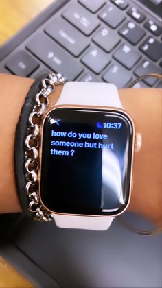 an apple watch with the message how do you love me and but hurt them?