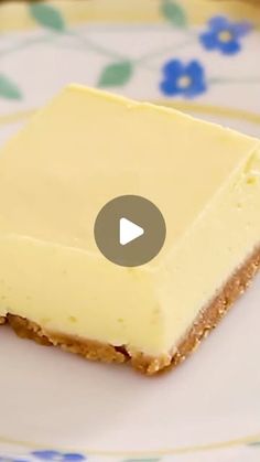 a piece of cheesecake sitting on top of a white plate with blue and green flowers