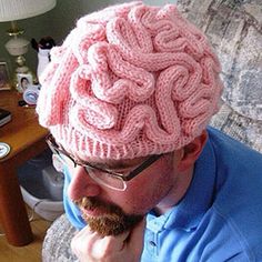 a man wearing a pink knitted brain hat