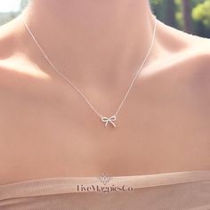 925 Sterling Silver Bow Necklace | Bow Pendant Necklace | Minimalist Necklace | Cute Jewellery | Ribbon Necklace | Gift for Her What's Included: 🌟1 x 925 Sterling Silver Bow Necklace🌟 🚚Free Shipping! 📆30 Day Money Back Guarantee 💛Handcrafted & Handmade with Pride Introducing our FiveMagpies Dainty Bow Necklace in stunning 925 Silver - the perfect new addition to your jewellery collection. Why choose this stunning piece? ✨ Minimalist class & elegance, providing the perfect finishing touch to any outfit, day or night. ✨ Durable and gorgeous 925 Sterling Silver for all day shine. ✨ Lightweight and comfortable chain & pendant combination, perfect for all day wear. I've been hand crafting jewellery for friends and family for many years, and have decided to follow my dream of making my hobb Cute Jewellery, Bow Pendant, Tiny Bow, Necklace Cute, Ribbon Necklace, Bow Necklace, Silver Bow, Necklace Minimalist, Stunning Earrings