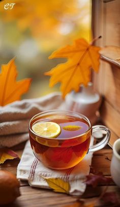 a cup of tea with lemon and some leaves