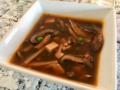 a white bowl filled with soup on top of a table