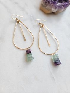 Pretty Fluorite Teardrop Hoop Earrings in your choice of 14K Gold Filled or Sterling Silver materials. Fun and unique earrings with a fun pop of color! Each piece is hand formed and hammered for texture and shape. The length is about 2 1/2 in. The fluorite are colors of green and purple and may vary. Thank you! Handmade Teardrop 14k Gold Hoop Earrings, 14k Gold Filled Dangle Hoop Earrings With Gemstone, Teardrop Hoop Earrings, Dangle Hoop Earrings, Amethyst Earrings, Unique Earrings, Earring Necklace, Green And Purple, Gold Filled