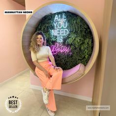 a woman sitting in a planter with the words, all you need is booze