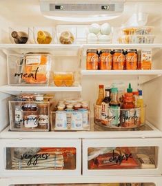 an open refrigerator filled with lots of food and condiments on top of it