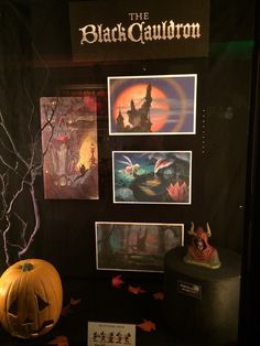 the black cauldron exhibit features pumpkins and other halloween related items on display