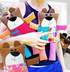 a woman holding three stuffed animals in her hands