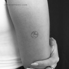 a woman with a small tattoo on her arm