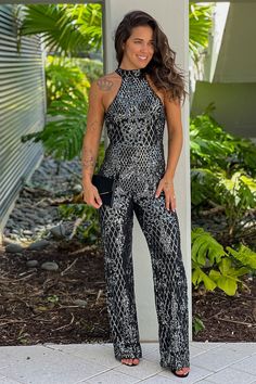 Black Sequined Halter Neck Jumpsuit Glamorous Fitted Halter Neck Jumpsuits And Rompers, Sequin Backless Jumpsuits And Rompers For Party Season, Glamorous Fitted Jumpsuits And Rompers For Gala, Fitted Embellished Jumpsuits And Rompers For Gala, Sequin Backless Jumpsuits And Rompers For Night Out, Glamorous Halter Neck Jumpsuit For Night Out, Elegant Backless Sequined Jumpsuits And Rompers, Glamorous Sequined Jumpsuits And Rompers For Party Season, Fitted Evening Jumpsuits And Rompers With Contrast Sequin