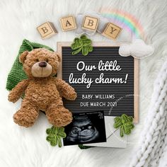 a baby announcement with a teddy bear next to it