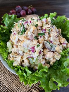 a salad in a bowl with lettuce and grapes