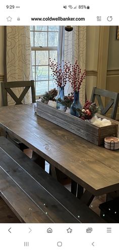 a wooden table with two benches in front of it and flowers on the top shelf