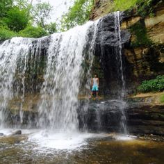 a person standing in front of a waterfall