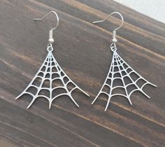 Dangle silver stainless steel spider web earrings, Spooky & cute Halloween jewelry Carefully handmade from silver plated hooks, huggie lever back hoops or clip on earrings, and 4cm (1.5") stainless steel cobwebs.  They come in a gift box, making them the perfect gift for the spooky horror or Halloween lover in your life. All packages are sent by priority mail with a tracking number. x Handmade in Germany x My other items can be found here: bysantana.etsy.com Favorite my shop to receive updates on new items! Spooky Silver Pierced Earrings, Spooky Silver Nickel-free Earrings, Spooky Nickel-free Silver Earrings, Spooky Silver Dangle Earrings, Spooky Silver Earrings For Gift, Silver Witchy Pierced Earrings, Silver Ear Wire Earrings For Halloween, Nickel Free Sterling Silver Witchy Earrings, Halloween Hypoallergenic Metal Jewelry