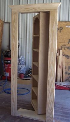 a tall wooden bookcase sitting inside of a building