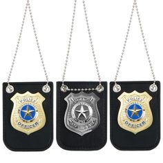 three police badges hanging from chains