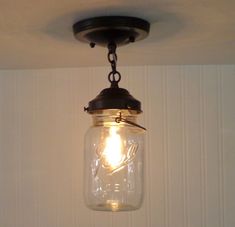 a mason jar light hanging from the ceiling