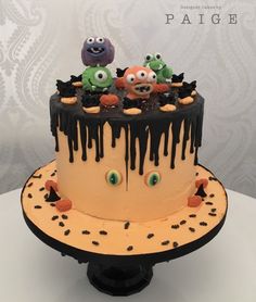 a cake decorated to look like monsters with chocolate icing on top and sprinkles all over it