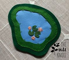 a close up of a piece of cloth with flowers on it and a green patch