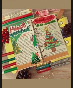 an open christmas planner with pencils and markers