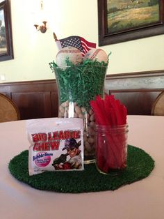 a baseball themed centerpiece on top of a table in a room with other items