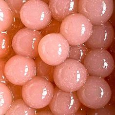 closeup of pink gummy bears in a bowl with water on the bottom and top