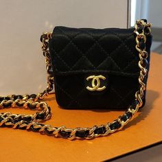 Authentic Collectible Chanel Mini Single Flap Bag Black Satin With 24kt Gold Plated Hardware 100% Original In Pristine Condition No Snags No Tarnish Wear Crossbody Or As A Necklace Drop Is 19.5" Bag Is 3"X3" Zero Series From The 80s Built Like A Little Tank But So Delicate And Pretty Mini Bags Will Be Featured In The Next 2 Chanel Collections And They Will Be Over $5k At Market If You Are A Collector You Know How Hard This Style Is To Find. The Chanel Satin Is Bulletproof And Stain Resistant And No Marks Or Scratching I Tend To Buy Multiples. I'm Pairing Down My Closet A Bit. I Have Over 20 Mini Bags And I'm Letting A Few Go... Slowly Comes With Chanel Box Last Three Photos Highlight Runwa Chanel Boy Wallet, Chanel Mini Flap Bag, Bag Necklace, Chanel Crossbody, Chanel Camellia, Chanel Box, Chanel Collection, Chanel Mini, Dior Jewelry