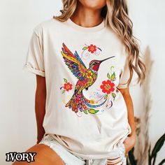 Embrace nature's beauty with our Floral Hummingbird Shirt, featuring a vibrant mandala design that's perfect for bird lovers and nature enthusiasts. This colorful tee makes a wonderful gift for her, whether she's a hummingbird lover or simply enjoys unique, artistic designs. Crafted from soft, Breathable fabric, it's perfect for casual wear, outdoor adventures, or even as a statement piece in a boho-inspired wardrobe. This shirt captures the essence of wildflowers and the delicate beauty of humm Summer Crew Neck T-shirt With Bird Print, Casual Summer Tops With Bird Print, Casual Bird Print Tops For Summer, Summer Cotton Tops With Bird Print, Casual Summer T-shirt With Bird Print, Mandala Bird, Boho Birds, Oversized T Shirt Dress, Comfort Colors Tee